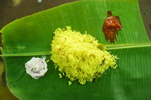 lemon rice served on a banana leaf